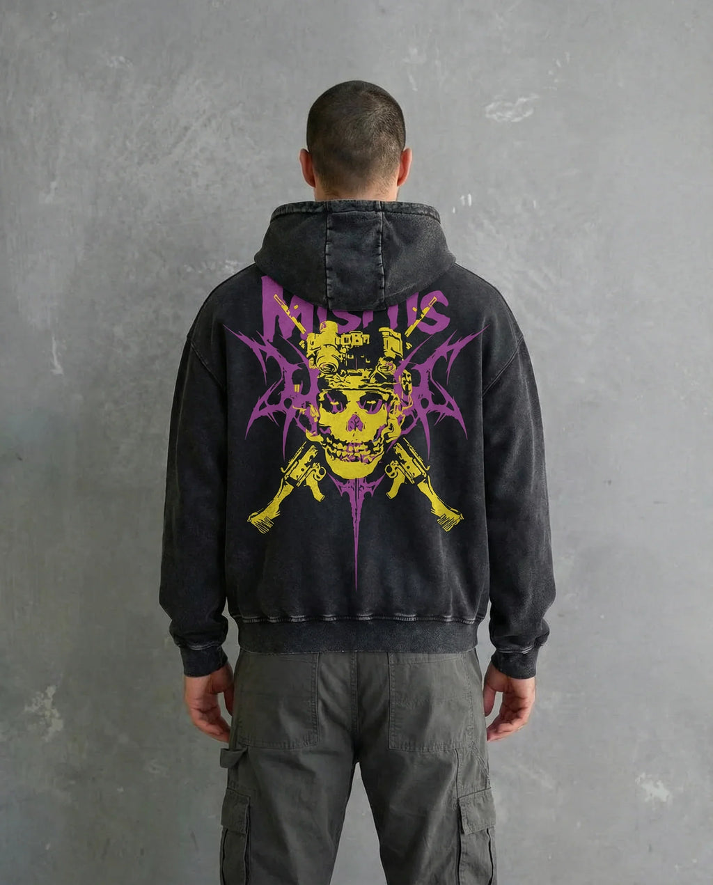 Back view of a model wearing a Jnorss Misfits Skull Uprising acid wash hoodie with a hood and distressed design.