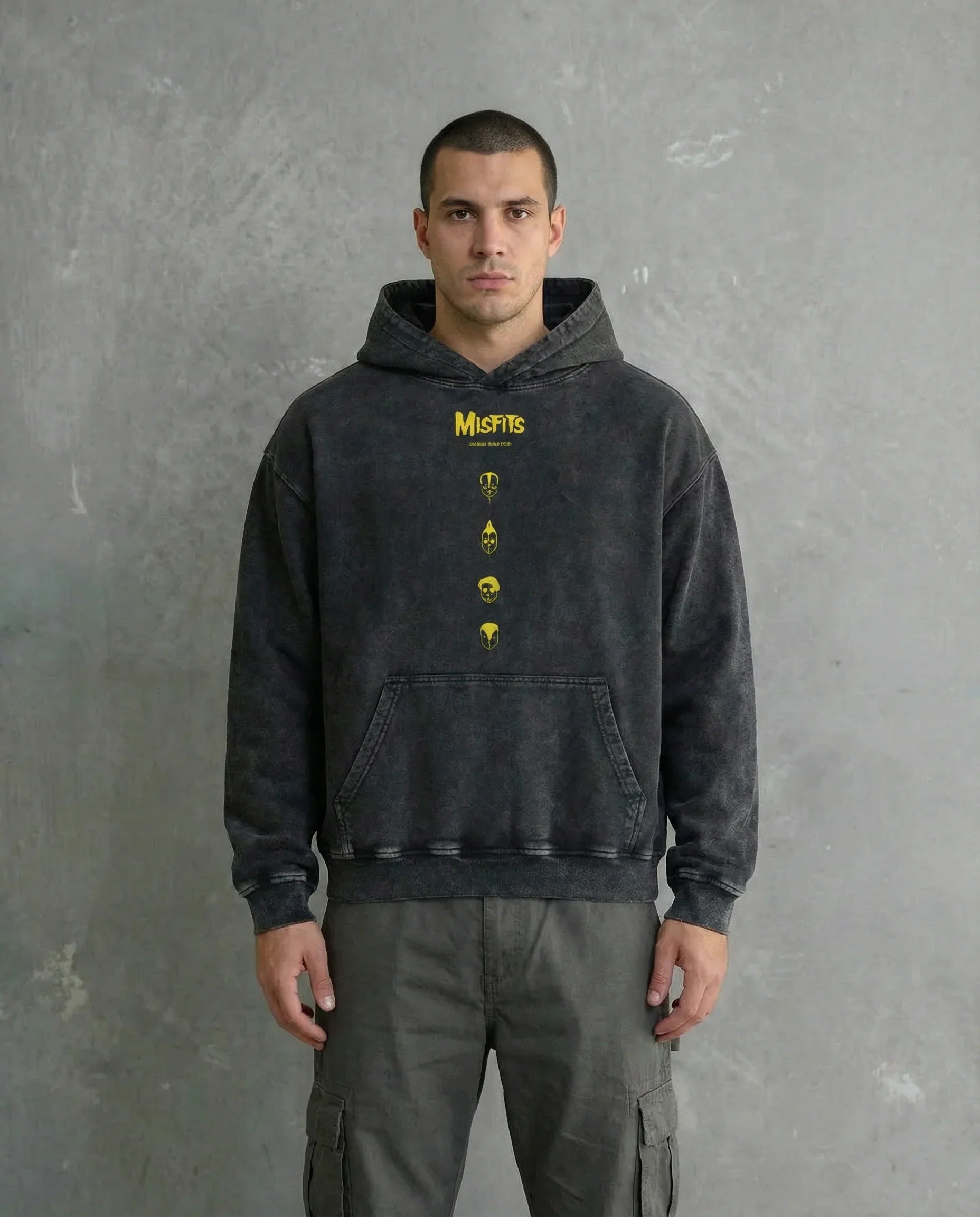 Front view of a model wearing Jnorss Misfits Skull Uprising acid wash hoodie, showcasing its bold skull graphic and relaxed fit.